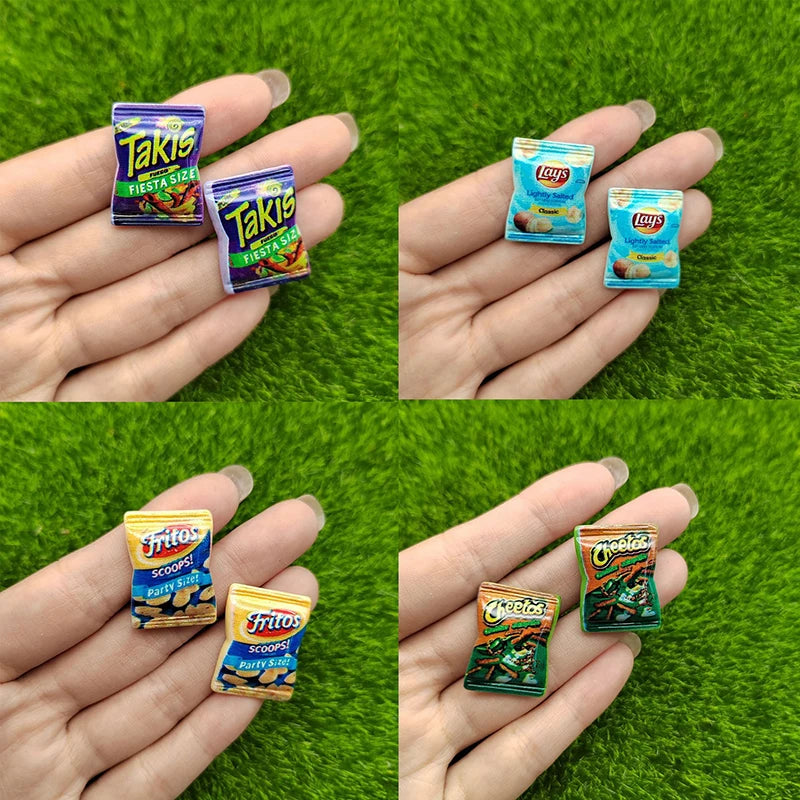 A set of ten colorful potato chip snacks from Takis and Fritos brands held in human hands against a green background.