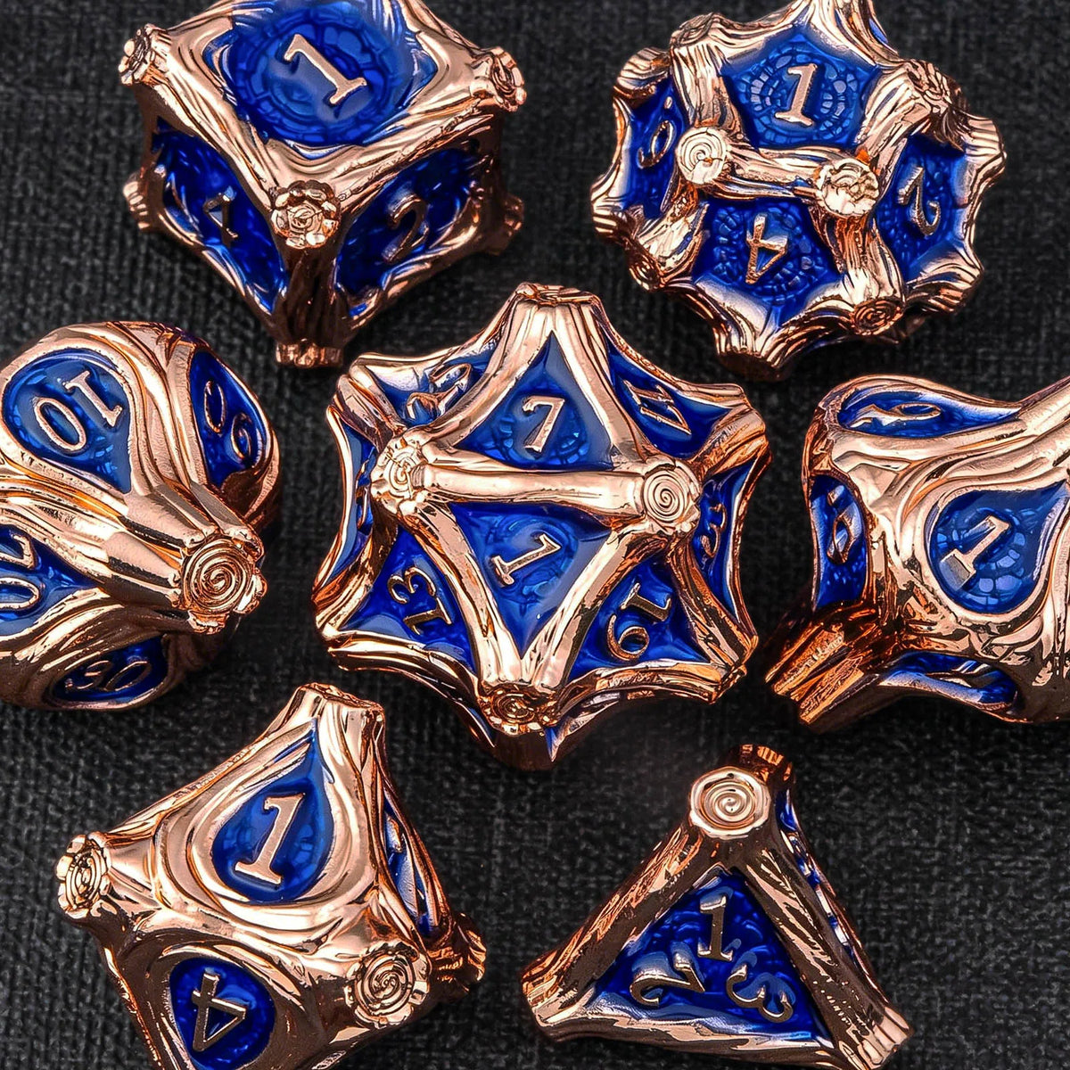 A set of ten premium zinc alloy metal dice in gold and blue are displayed on a dark surface.