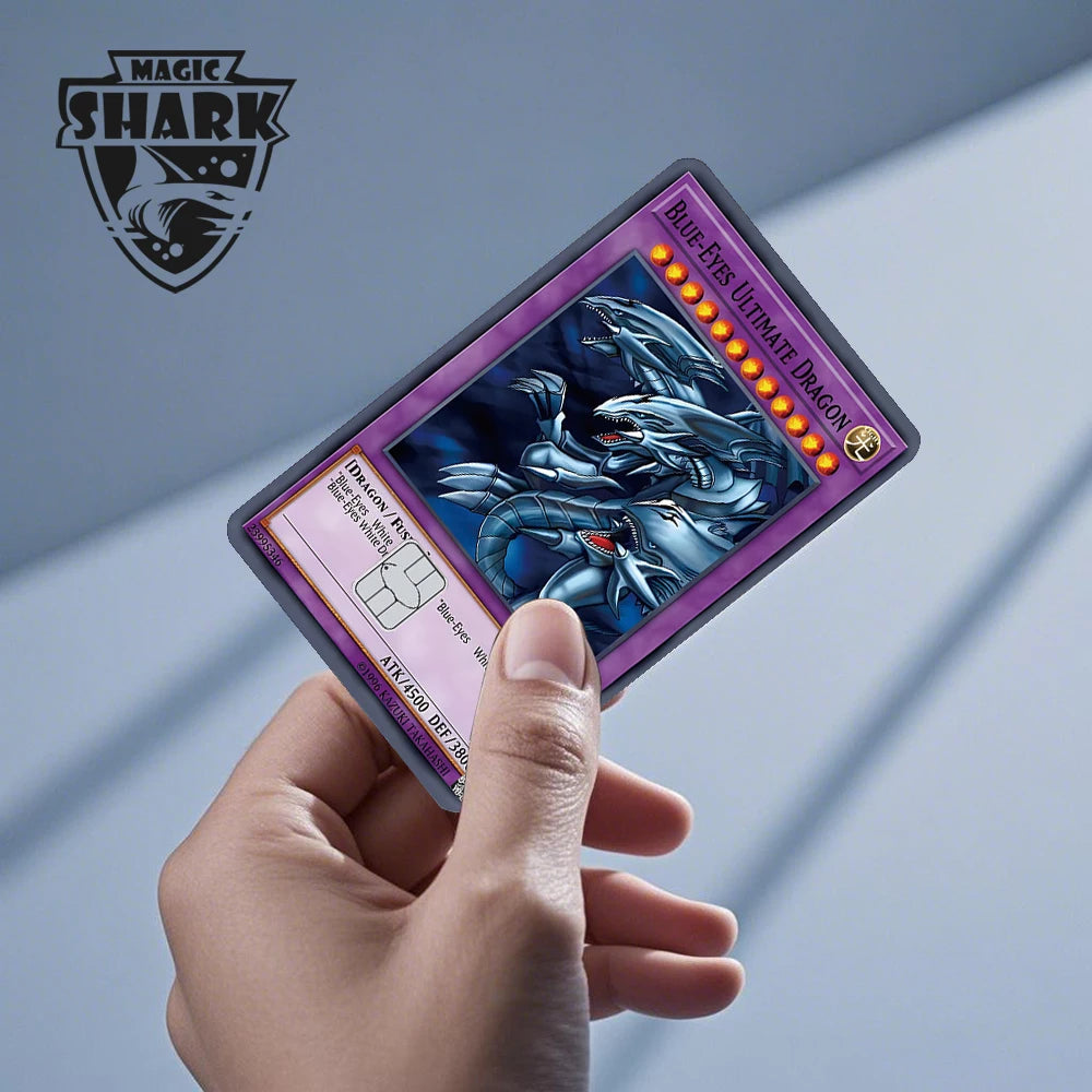A hand holds a Magic Shark Blue-Eyes Ultimate Dragon card skin sticker displaying an anime dragon illustration.