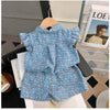 A blue floral print girls' sleeveless shirt and shorts set displayed on a hanger.