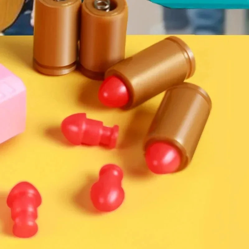 A collection of small, brown and red mini shell-ejecting fidget pistols arranged on a yellow surface.