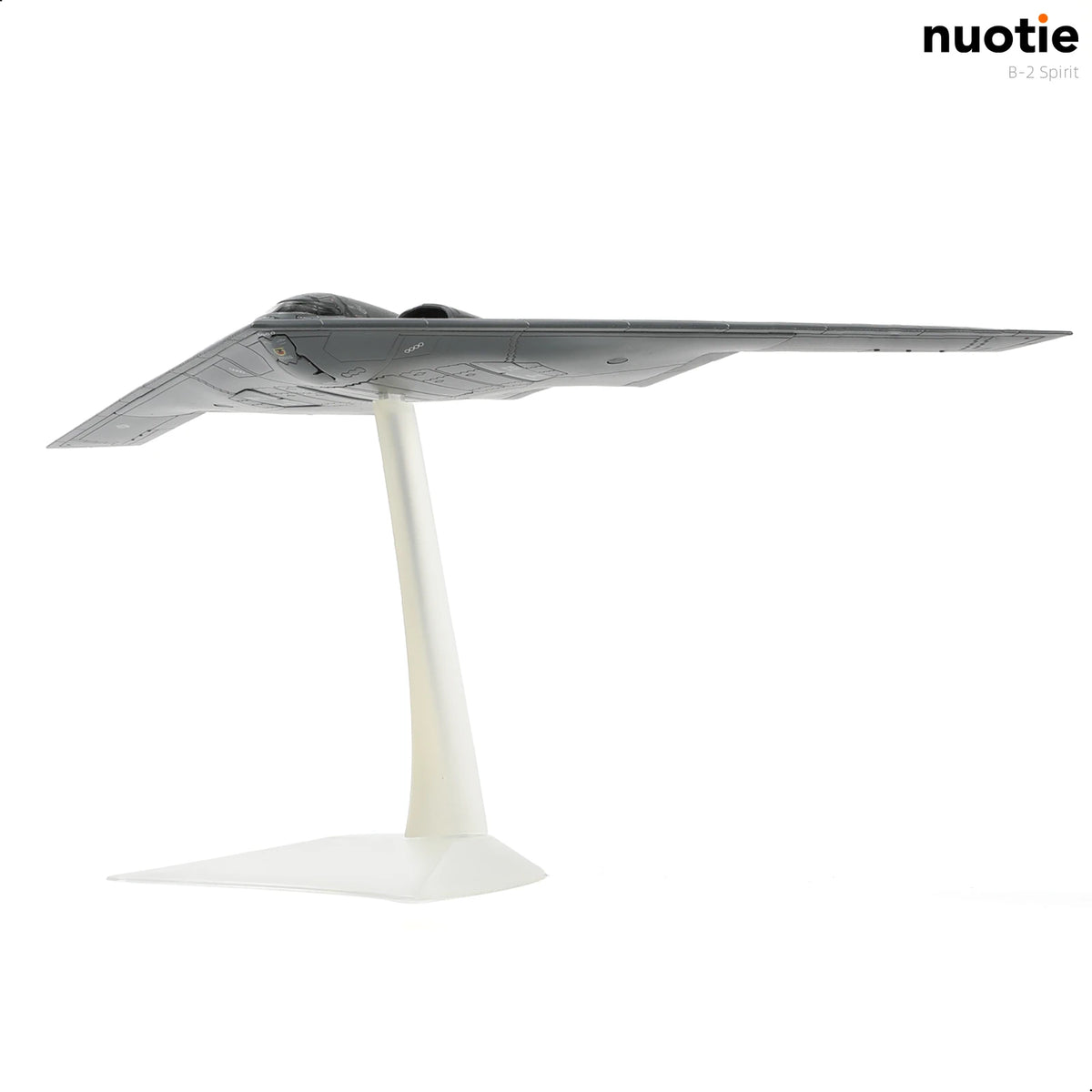 A gray B-2A Spirit stealth bomber diecast model displayed on a white stand.