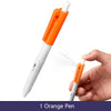 An orange ballpoint pen is shown being used to spray a fine mist of water onto a hand.