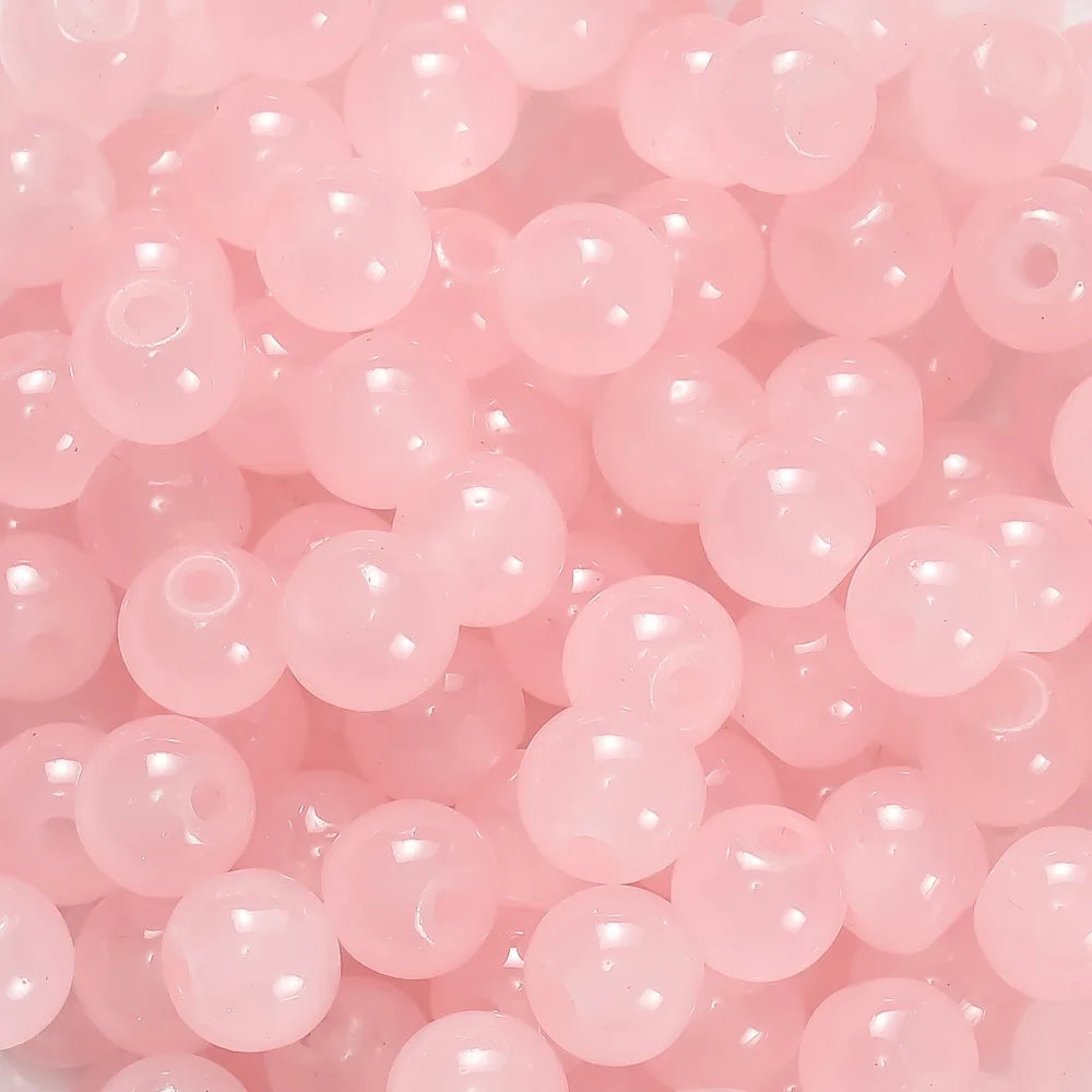 A close-up view of pink glass round beads for DIY jewelry making