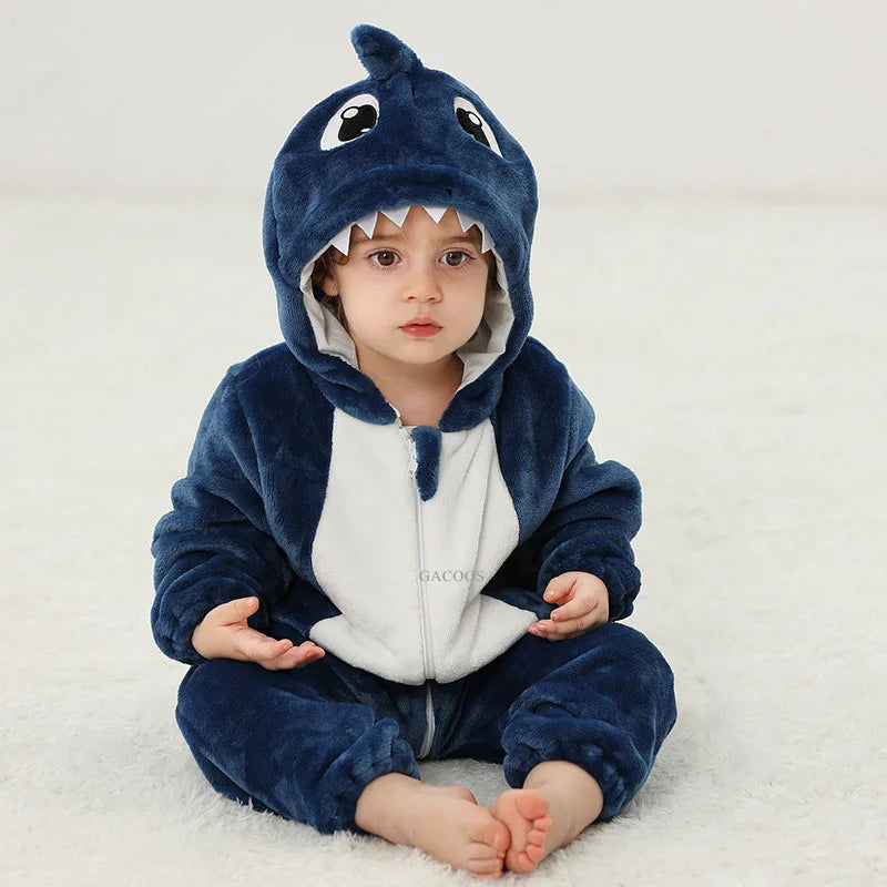 A baby wearing an adorable blue hooded romper designed to look like a shark or sea creature.