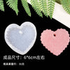 A set of flexible silicone resin molds in heart shapes, pink and clear/white, displayed against a dark background.