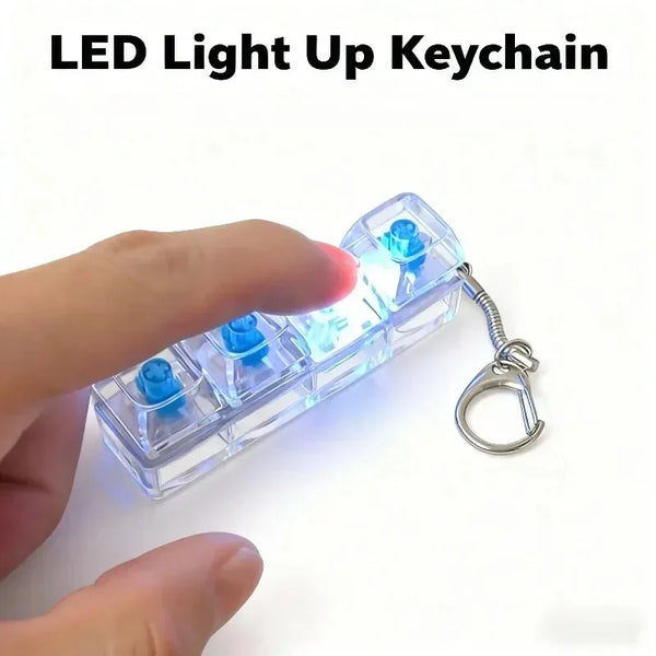 A hand holds a clear LED light up keychain featuring multiple blue light-up components.
