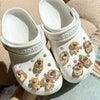 A pair of white Crocs shoes decorated with glow-in-the-dark capybara charms