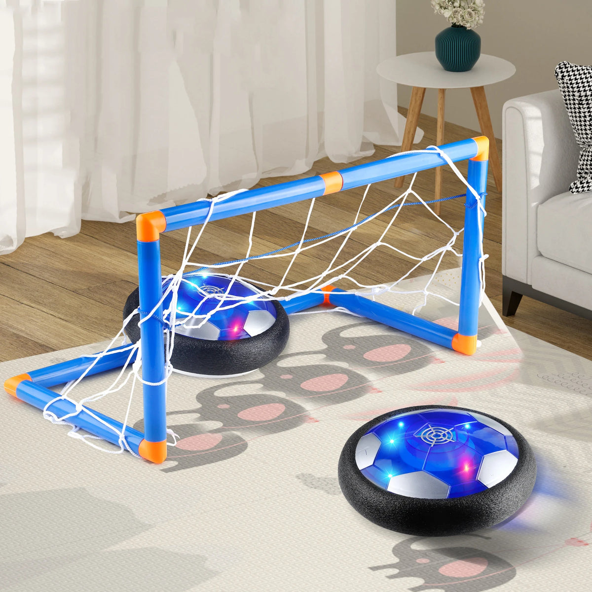 Blue and orange LED hover soccer goal net and ball set on a white rug
