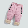 Pink waterproof winter pants for kids with fleece lining and black drawstrings
