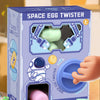 A box of Space Egg Twister toys with various colored eggs and a purple twist mechanism displayed on a wooden surface.