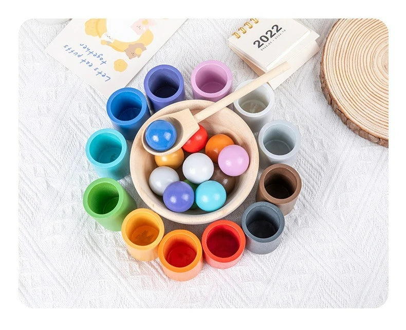 Montessori wooden color sorting game featuring rainbow balls and cups in various colors.