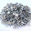 A pile of silver acrylic alphabet letter beads for jewelry making and crafts