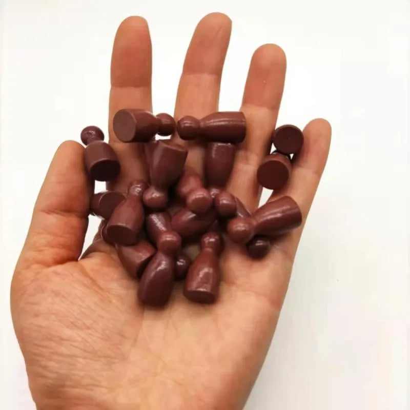 A hand holds a set of ten wooden chess pawns for board games.