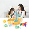 A woman is demonstrating a kids electric play dishwasher set with realistic water cycle to a child.