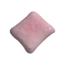 A square, pink squishy toy with a slightly textured surface.