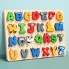 A wooden alphabet puzzle showing uppercase letters A through Z in various colors and shapes for learning.
