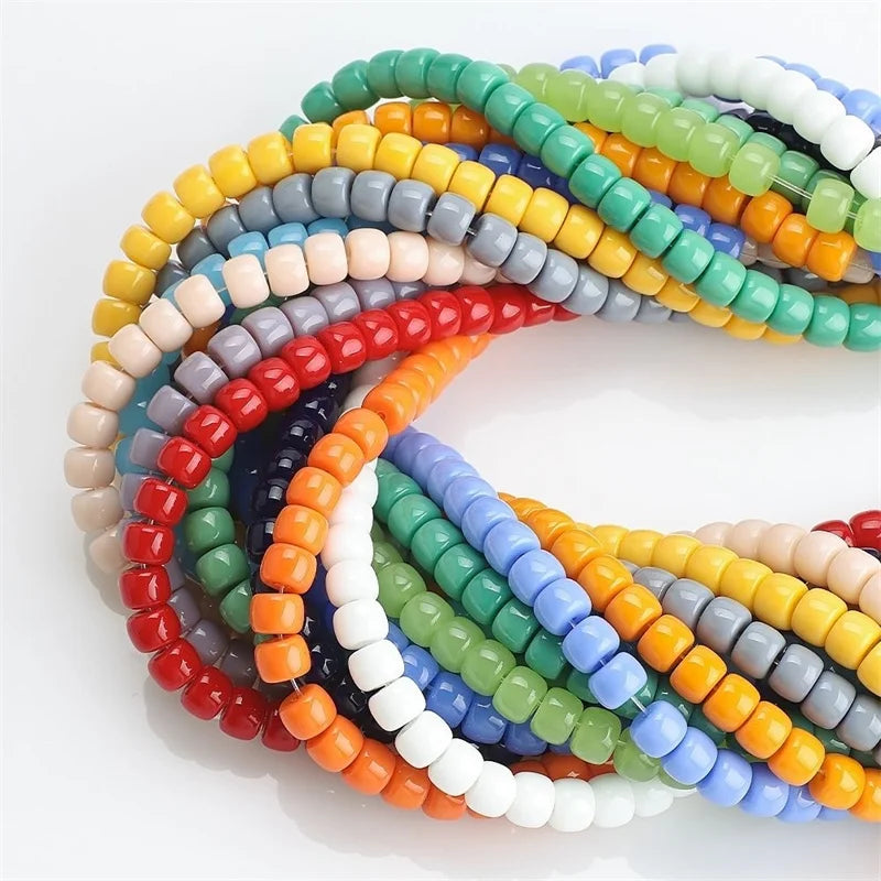 A colorful strand of rainbow pony beads in various shades of blue, green, yellow, and orange.
