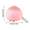 A pink, peach-shaped squeeze toy designed for stress relief.