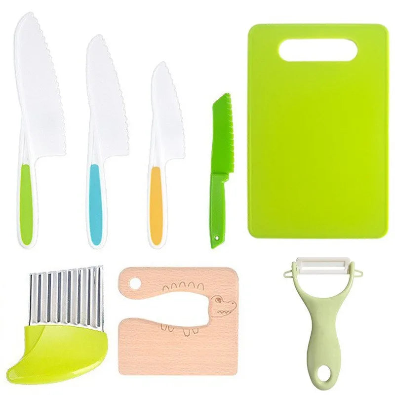 A set of safe plastic play knives and a green cutting board with a wooden food cutter tool.