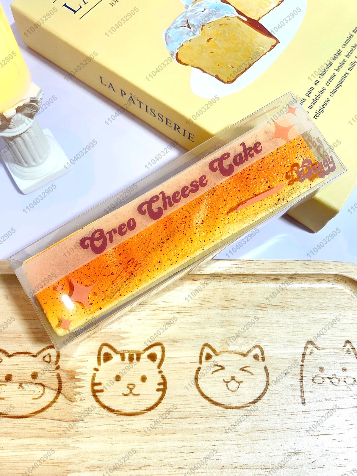 A clear plastic package of Oreo Cheese Take butter stick squishy toy resting on a wooden surface.