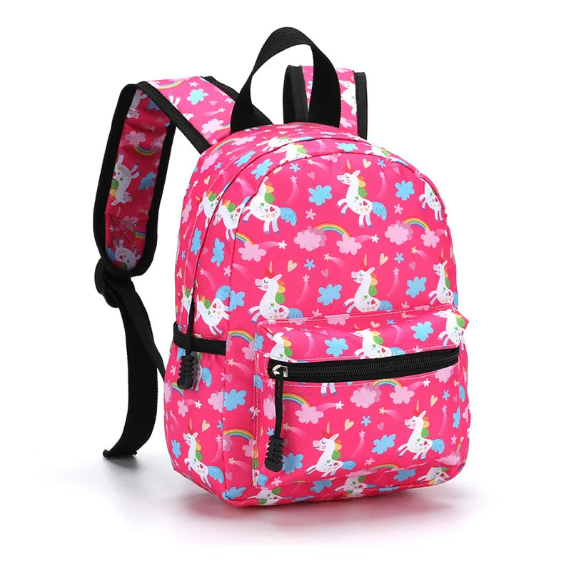 A bright pink cartoon kids backpack featuring unicorns and rainbow patterns.