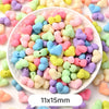 A bowl filled with pastel bear-shaped acrylic craft beads in various shades of pink, yellow, blue, and purple.