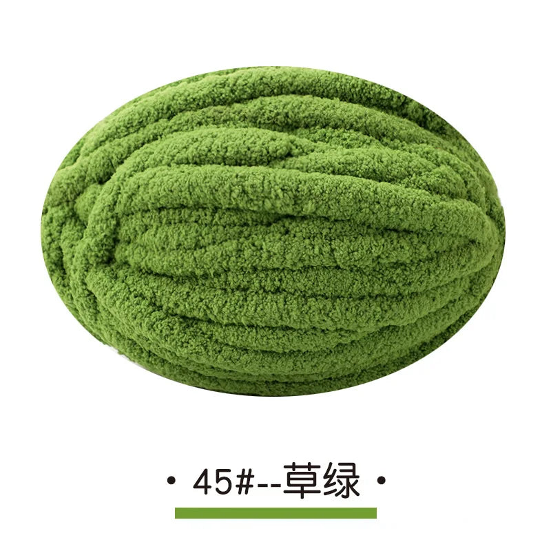 A ball of olive green chunky chenille yarn for hand knitting projects.