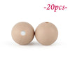 Two round, beige silicone beads are shown against a white background.