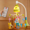 A yellow musical mobile with various animal shapes hangs from a curved wooden frame.