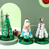 A set of crystal growing trees with star toppers displayed on a green and white background.