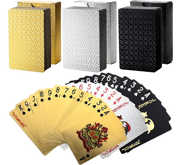 A set of luxury gold foil playing cards and a stack of black playing cards.