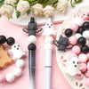 A set of silicone crafting beads featuring black and white bats and ghosts arranged on a pink background.