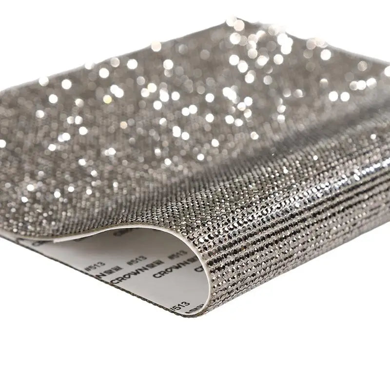 Silver sparkling rhinestone adhesive tape rolled up for DIY crafts and decor
