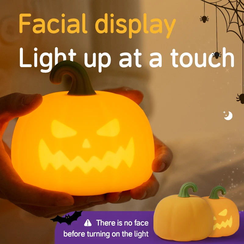 A hand holds a glowing orange pumpkin LED night light with a carved face, demonstrating the touch control feature.