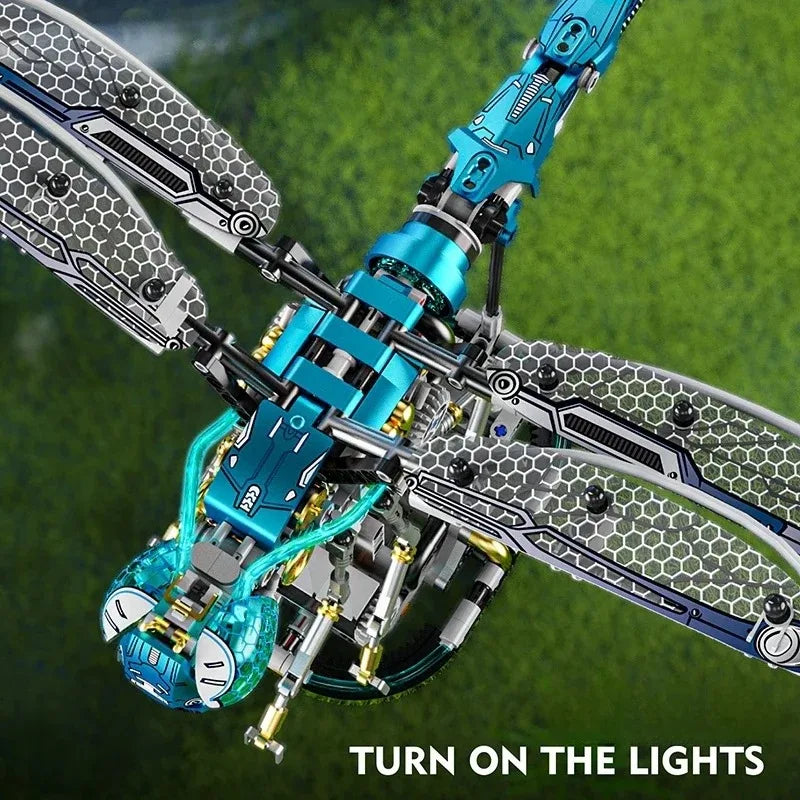 Close-up of a detailed mechanical model kit featuring blue and silver components, set against a green background.