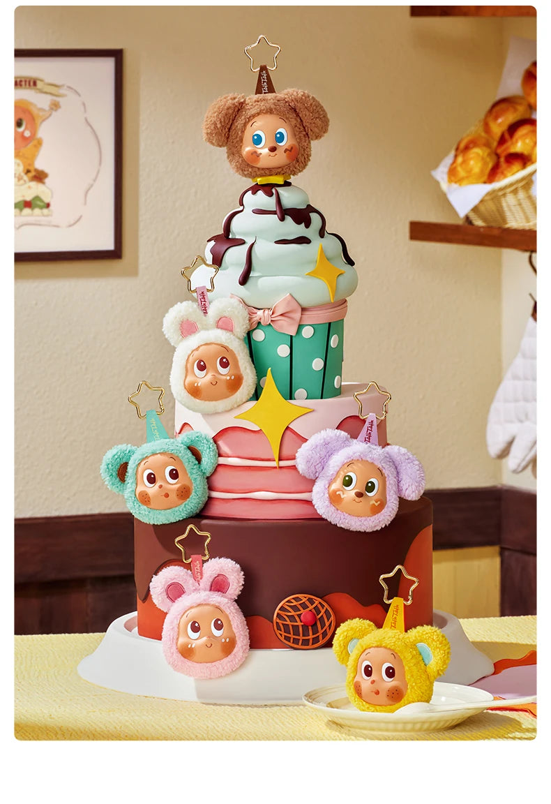 A tiered cake decorated with adorable animal-themed toppers and green and pink frosting.