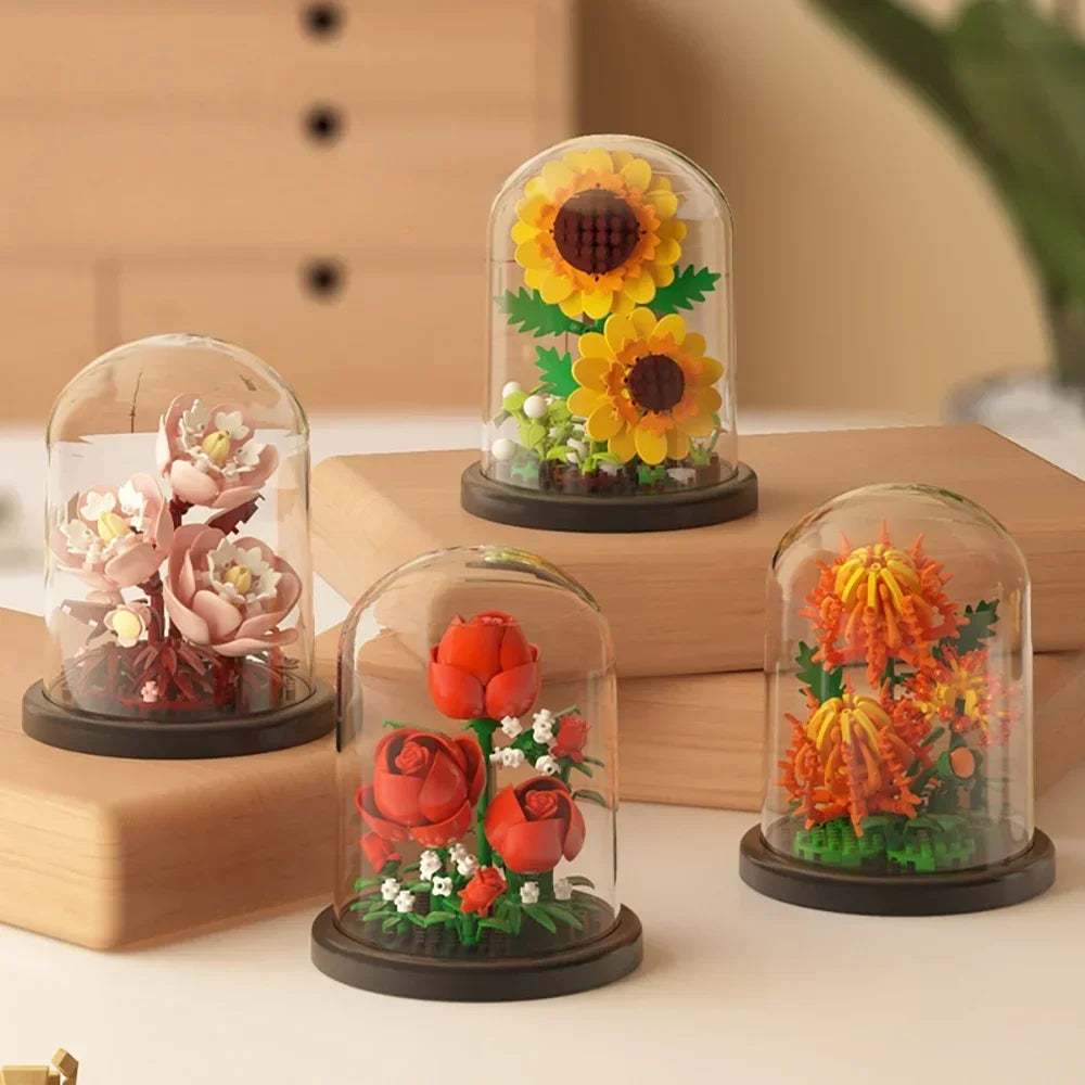 A set of glass cloches displaying various dried flowers and greenery used for DIY bouquet building blocks.