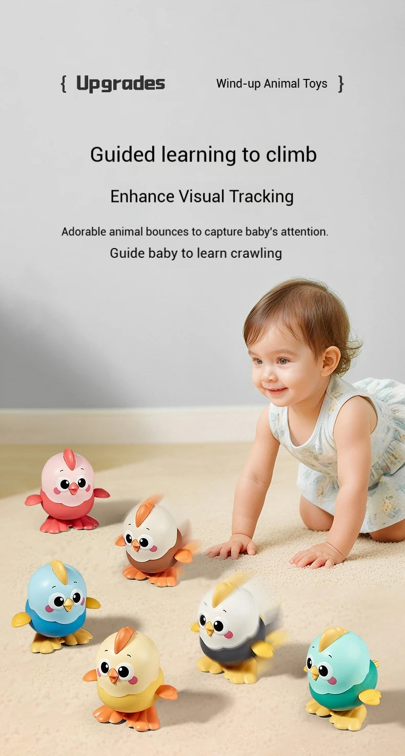 A baby is interacting with various wind-up animal toys, including a chick toy.