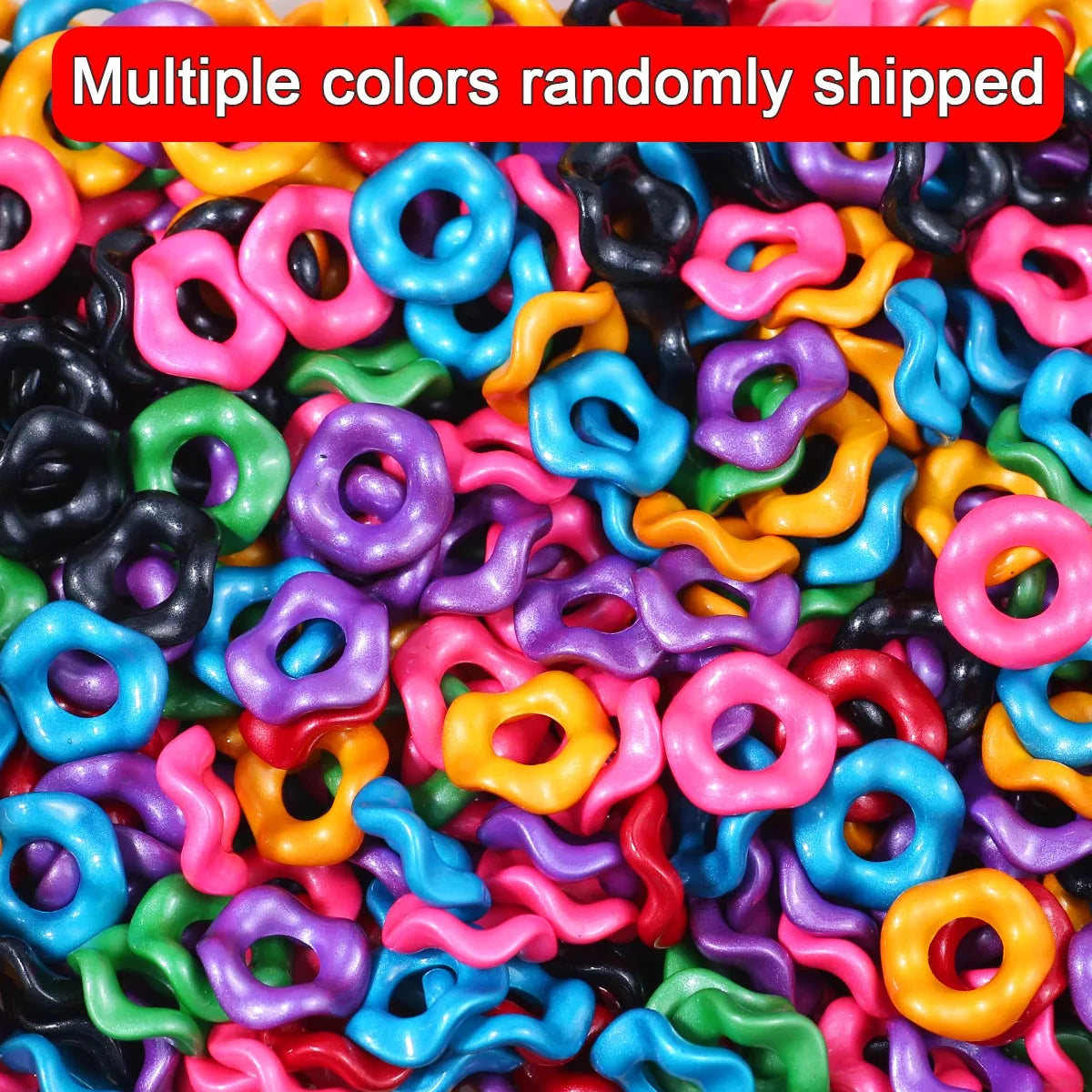A close-up of multiple colors of wave-patterned acrylic beads randomly shipped for jewelry making