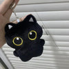 A black plush cat with large yellow eyes is shown against a white slatted background.