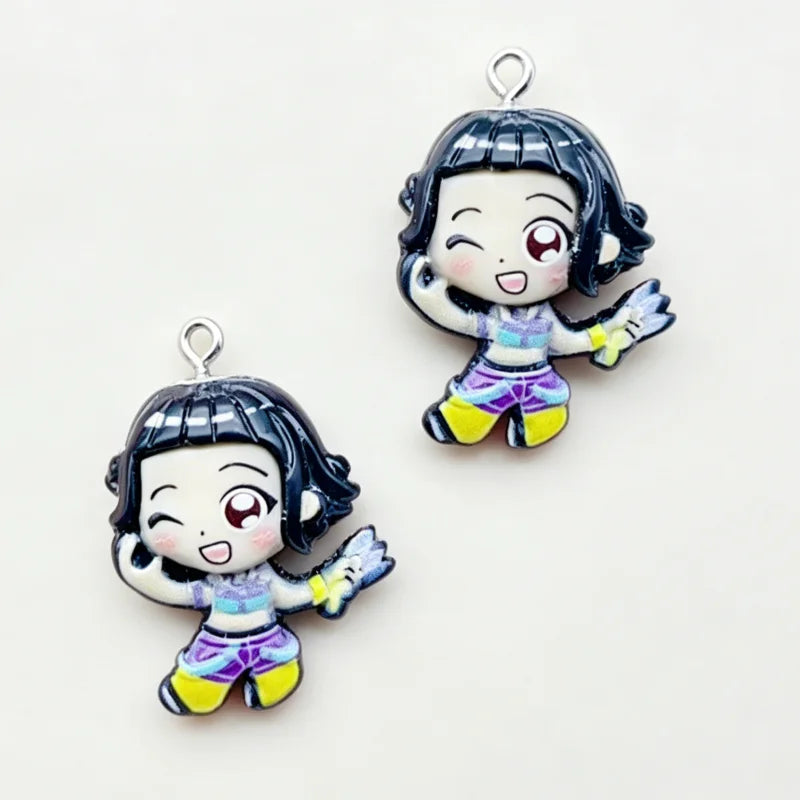 A set of 11 cartoon resin pendant charms featuring a girl with dark hair and purple and yellow clothing.