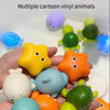A collection of multiple colorful vinyl cartoon animals, including a yellow star, orange, blue, and green shapes, held in a h