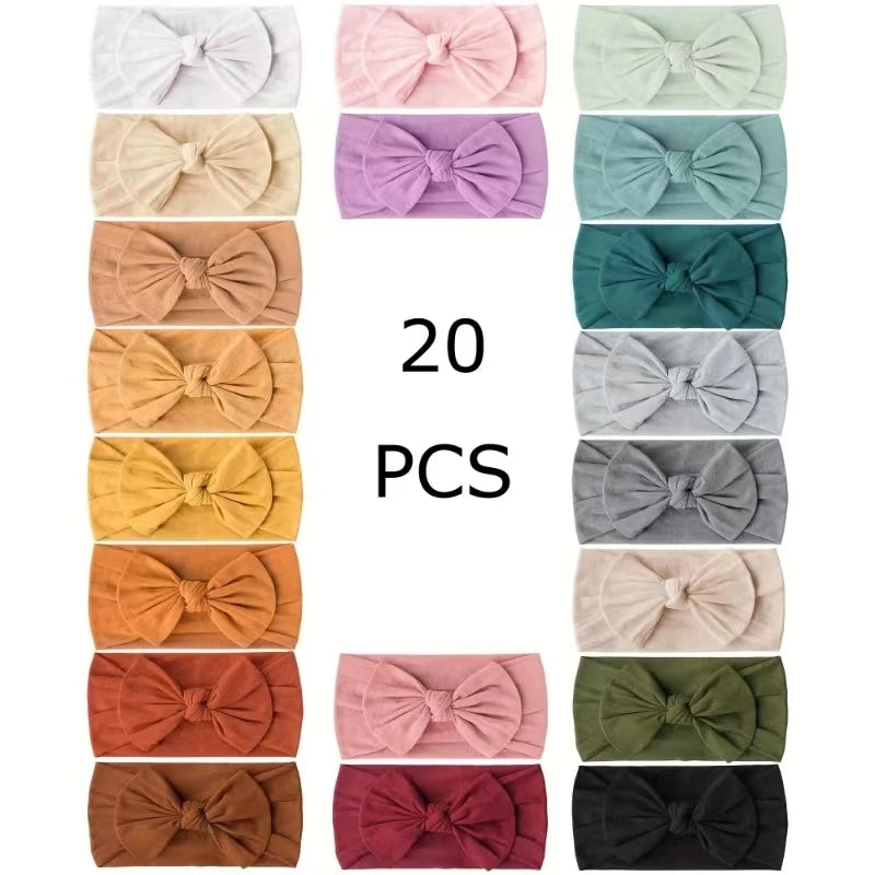 A collection of 20 nylon knit bow headbands for baby girls in various pastel and earthy colors.