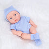 A realistic soft vinyl reborn baby doll wearing a blue striped outfit and a matching hat, lying on white fabric.