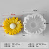 A yellow sunflower silicone mold for candle making and soap crafting shown next to its corresponding white mold.