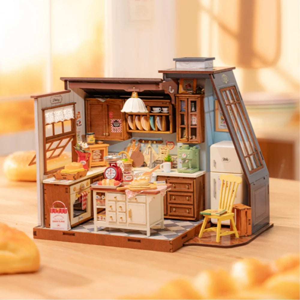 A miniature dollhouse kit depicting a cozy baking kitchen with wooden cabinets and tools.