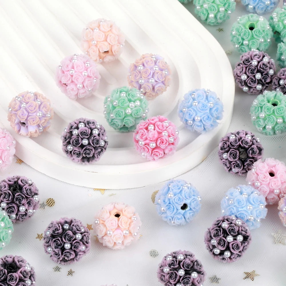 A collection of pink, purple, and blue rose flower ball acrylic beads for jewelry making