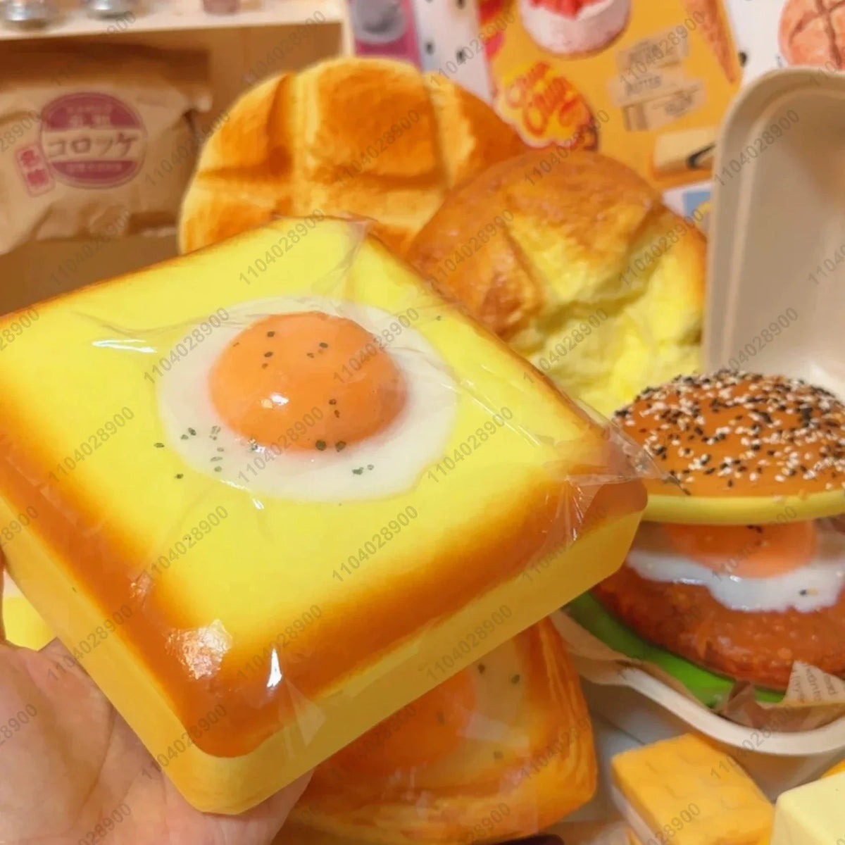 A yellow squishy fried egg toast stress relief toy is shown next to a golden baked item.