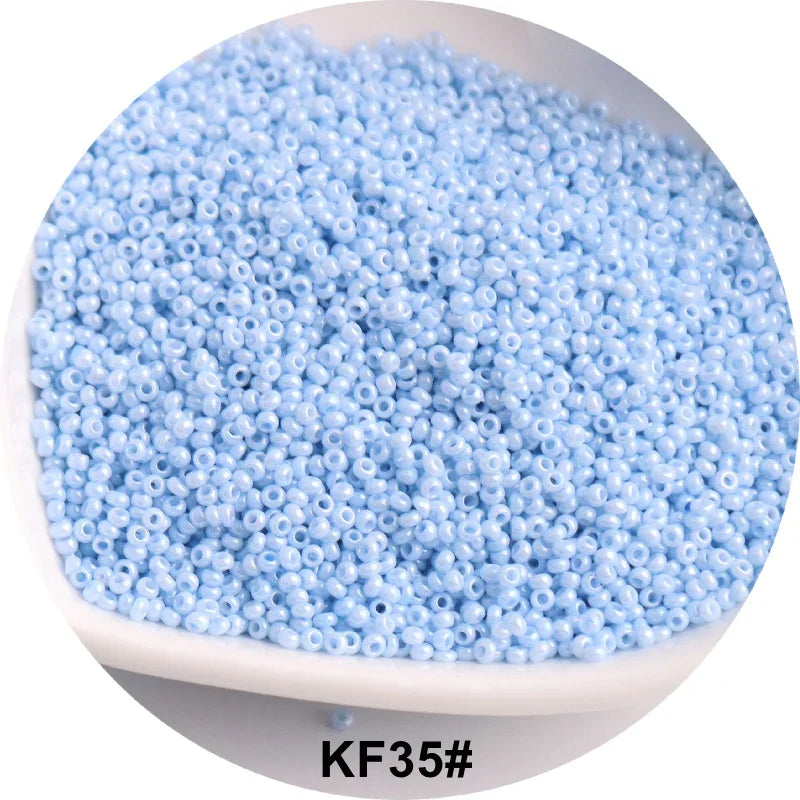 A pile of light blue 1.5mm solid glass seed beads for jewelry and craft.